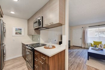 Kitchen with Hardwood Inspired Floors, Stove Top and view of Living Room